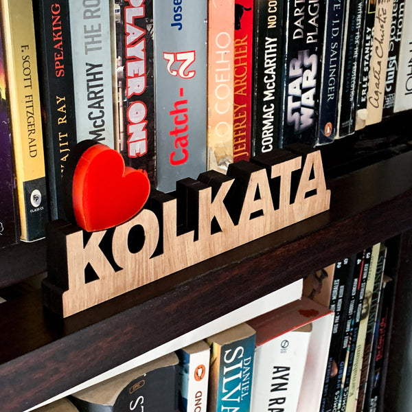 love kolkata signage on a bookshelf